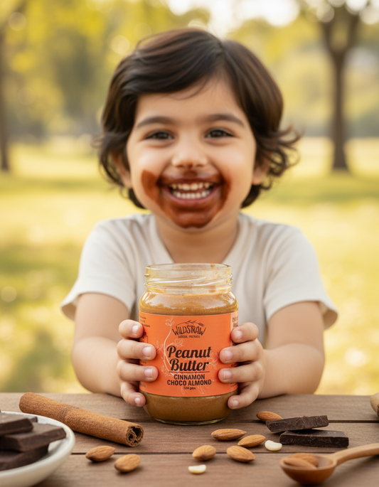 Child holding a jar of peanut butter outdoors with a blurred natural background